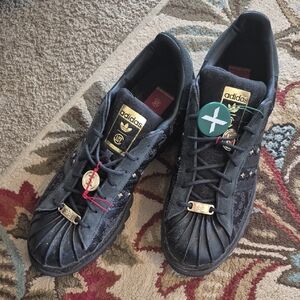 Adidas Black Rockstar Sneakers with Gold Accents